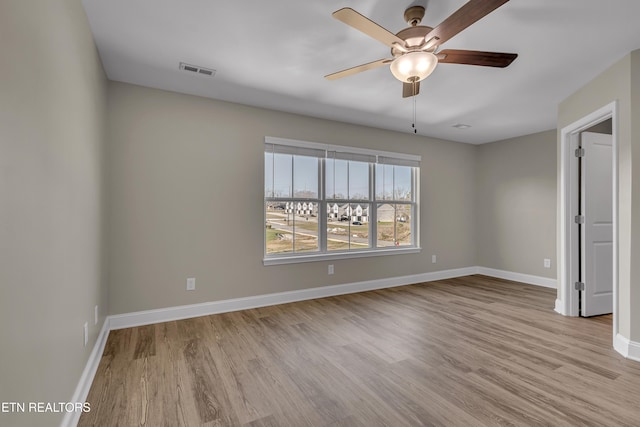 spare room featuring light wood-type flooring and ceiling fan