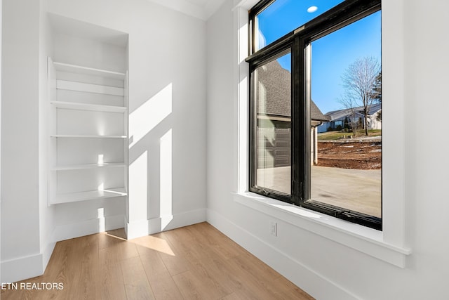 interior space featuring hardwood / wood-style flooring and built in shelves