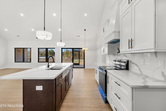 kitchen featuring appliances with stainless steel finishes, decorative backsplash, sink, white cabinetry, and decorative light fixtures