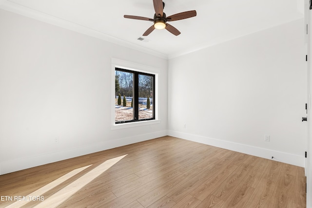 spare room with ceiling fan, light wood-type flooring, and crown molding