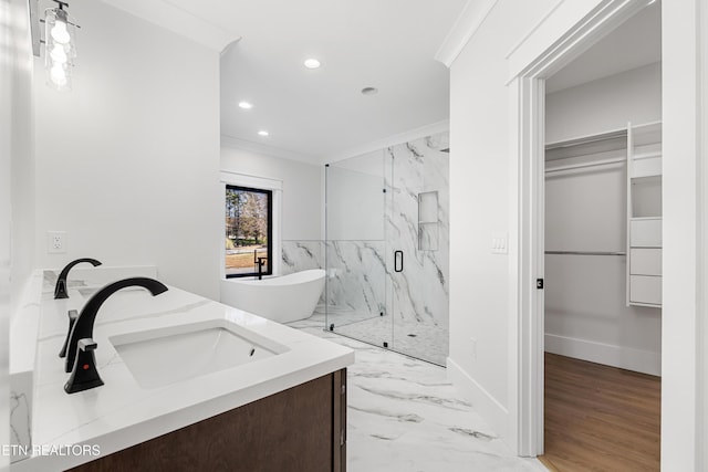 bathroom featuring separate shower and tub, crown molding, and vanity