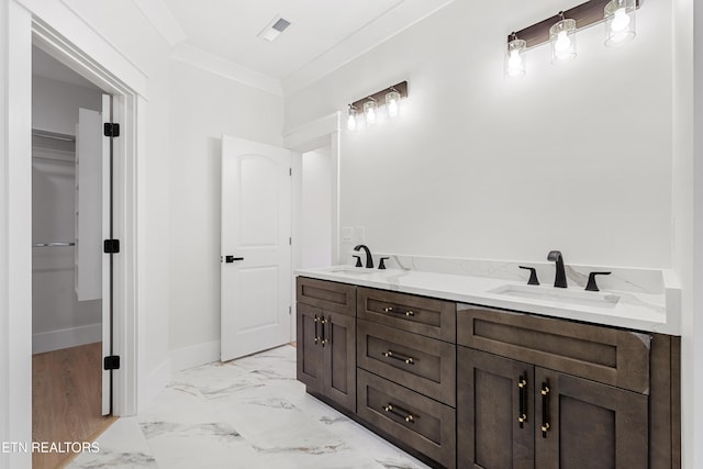 bathroom with vanity and crown molding