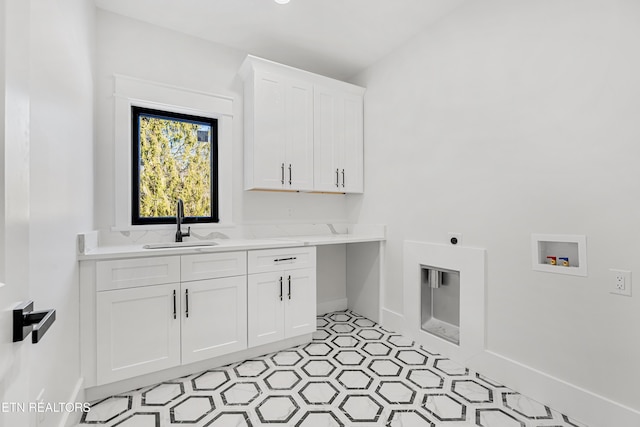 laundry area with sink, cabinets, hookup for a washing machine, and hookup for an electric dryer