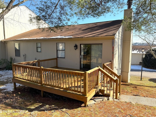 back of property featuring a wooden deck