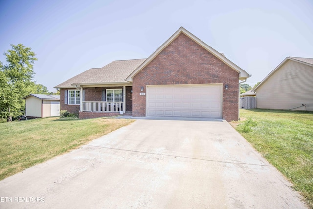 view of front of home with a porch, a front lawn, and a garage