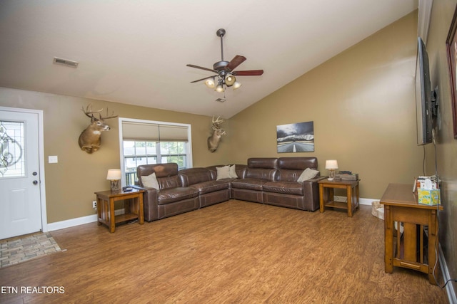 living room with lofted ceiling, ceiling fan, and light hardwood / wood-style floors