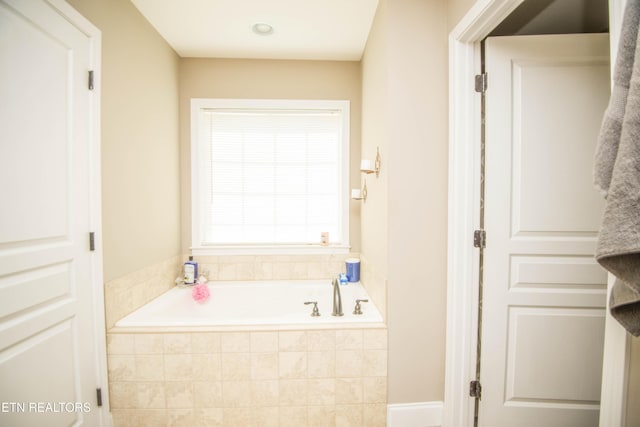 bathroom with tiled tub