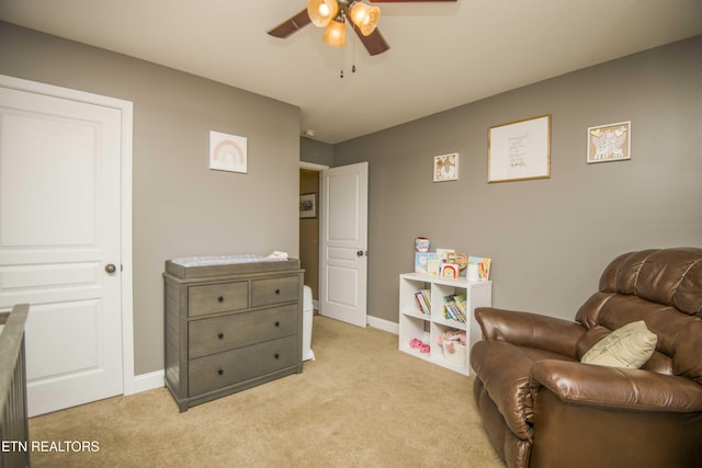 sitting room featuring light carpet and ceiling fan