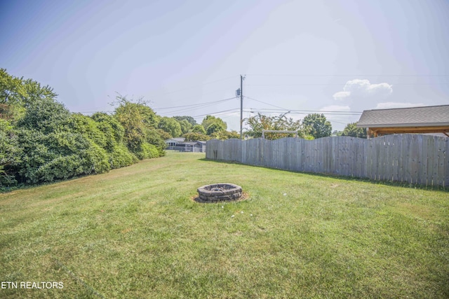 view of yard with a fire pit