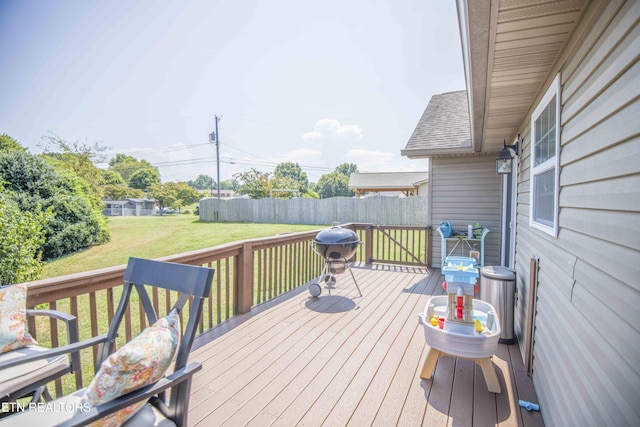 wooden deck featuring a yard