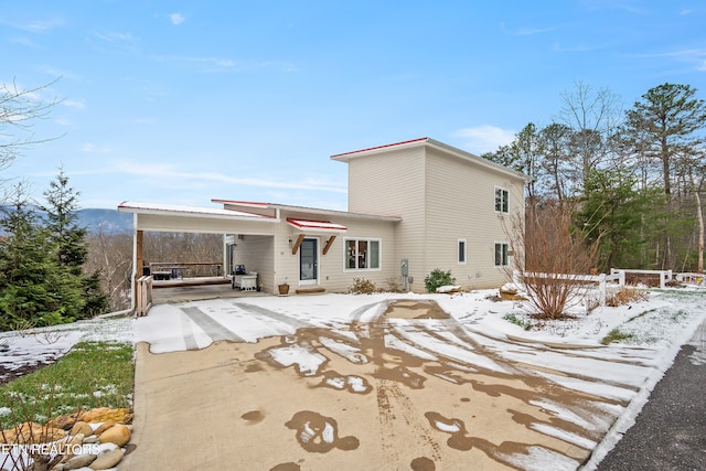 view of snow covered back of property