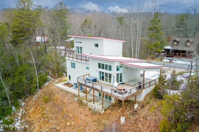 back of house with a wooden deck