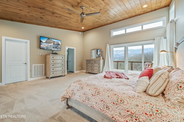 bedroom featuring a high ceiling, wooden ceiling, light carpet, and ceiling fan