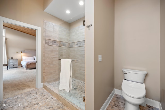 bathroom with toilet and a tile shower