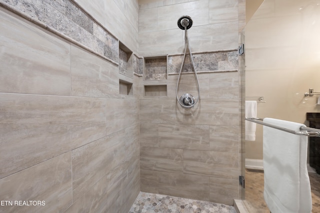 bathroom with tiled shower