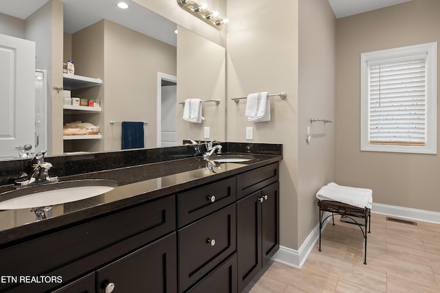 bathroom featuring built in shelves and vanity