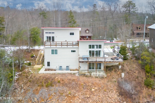 rear view of property with a wooden deck