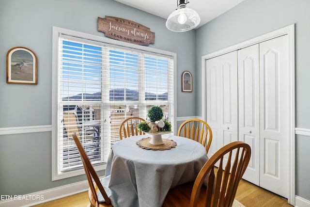 dining room with light wood-style floors and baseboards