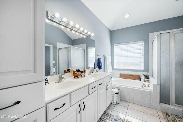 bathroom with lofted ceiling, a bath, a shower stall, and a sink