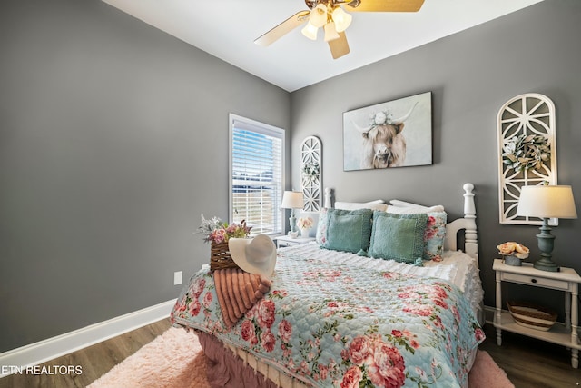 bedroom featuring wood finished floors, baseboards, and ceiling fan