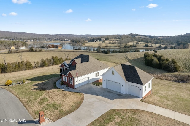 birds eye view of property with a rural view and a water view