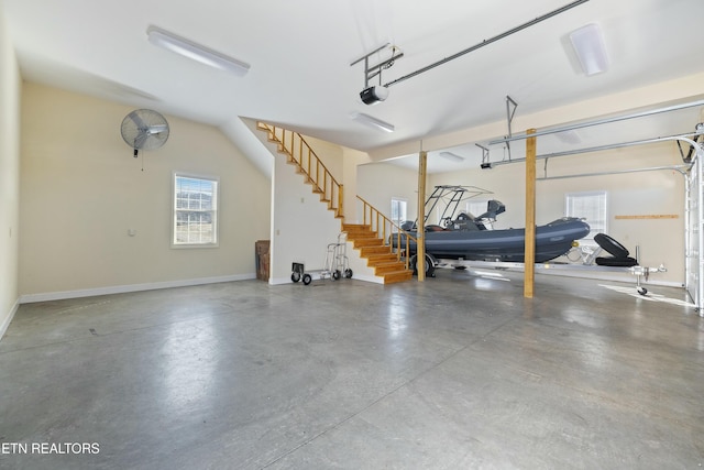 garage with baseboards and a garage door opener