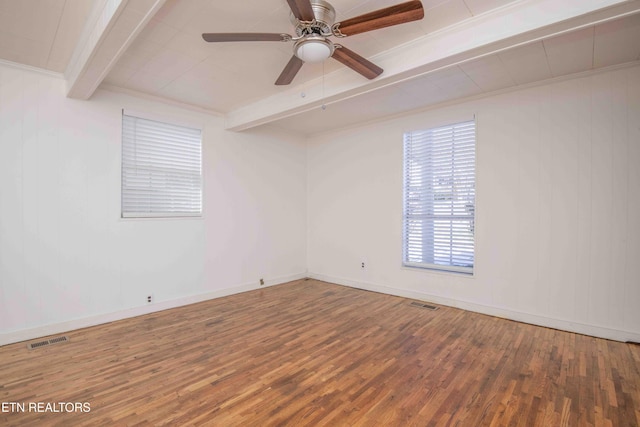 empty room with ceiling fan, ornamental molding, beam ceiling, and hardwood / wood-style flooring