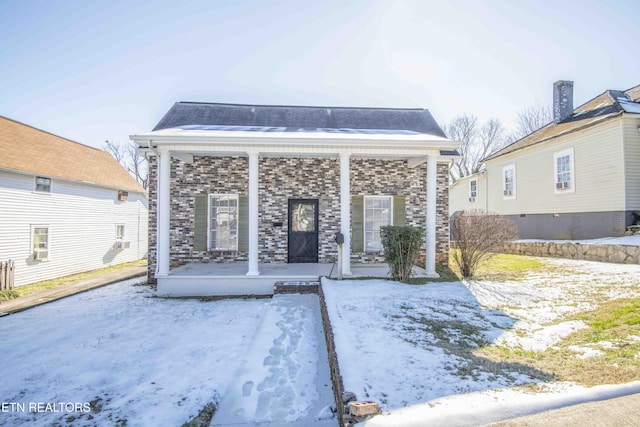 snow covered property featuring a porch