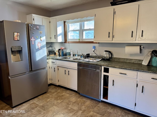 kitchen with sink, stainless steel appliances, and white cabinets