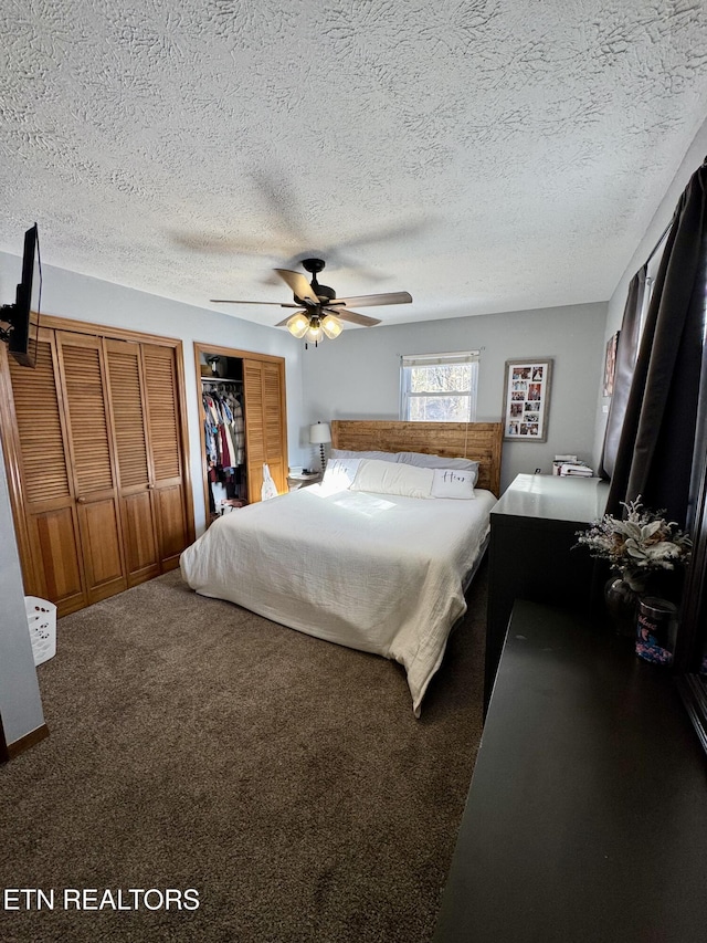 bedroom with ceiling fan, carpet floors, and a textured ceiling