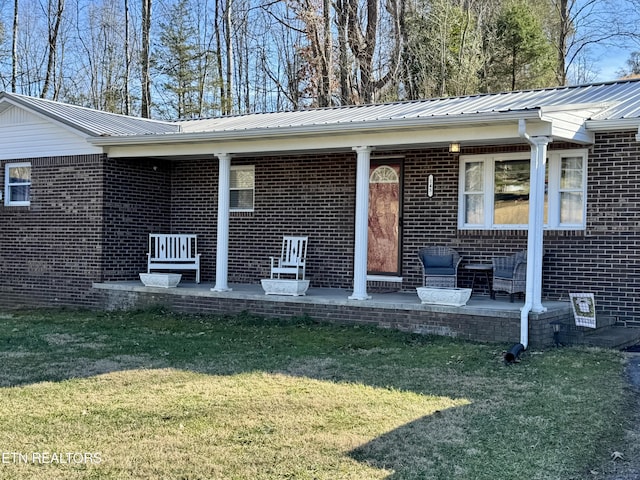 doorway to property featuring a yard and a patio area