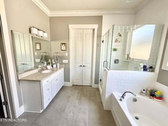 bathroom with plus walk in shower, crown molding, and vanity