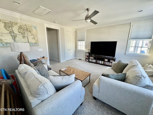 living room with light colored carpet, ceiling fan, and crown molding