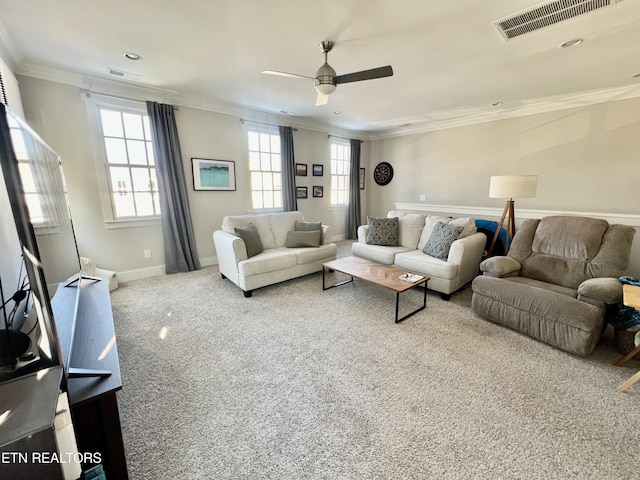 living room with ornamental molding, ceiling fan, and carpet flooring