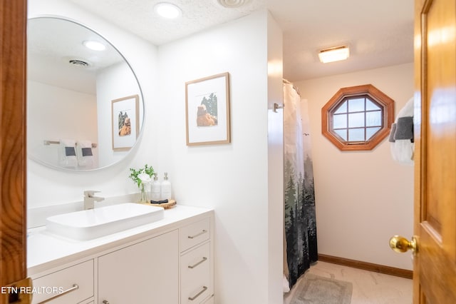 bathroom with tile patterned flooring, vanity, a textured ceiling, and a shower with shower curtain