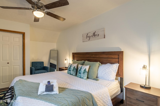 bedroom with ceiling fan, vaulted ceiling, and a closet