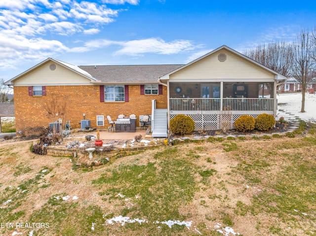 back of property featuring central air condition unit, a patio area, and a sunroom