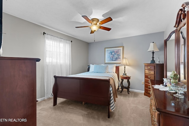 carpeted bedroom with a textured ceiling and ceiling fan