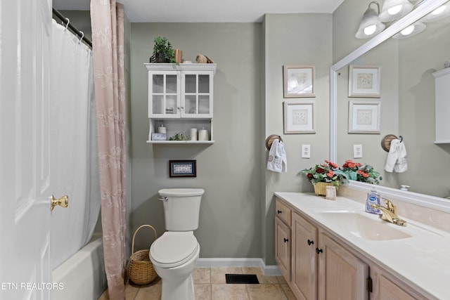 full bathroom with shower / tub combo, tile patterned floors, vanity, and toilet