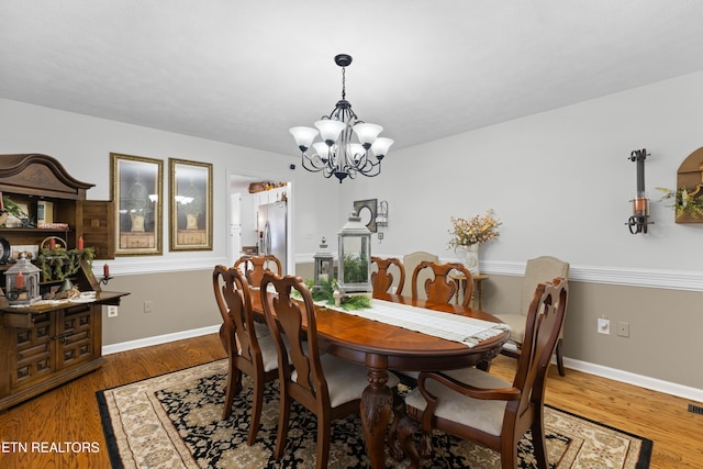 dining area featuring a chandelier and hardwood / wood-style floors