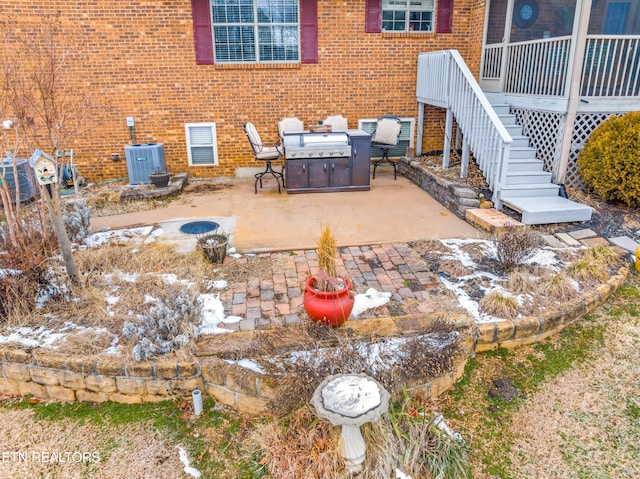 view of patio / terrace featuring a jacuzzi and central AC