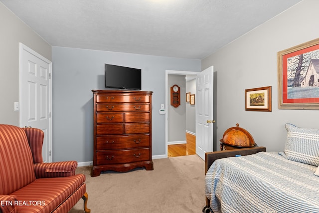 bedroom featuring light colored carpet