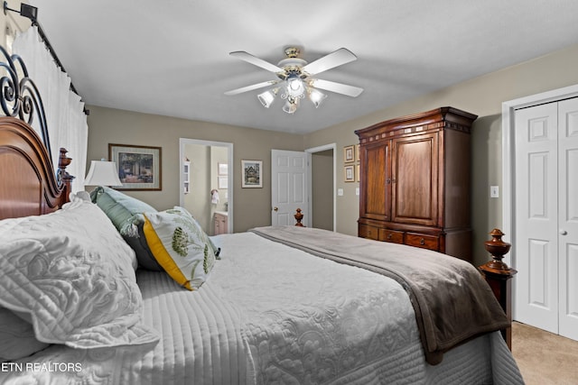 carpeted bedroom with connected bathroom, a closet, and ceiling fan