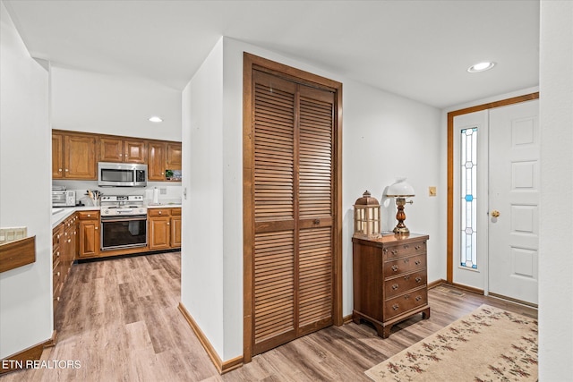 kitchen with stainless steel appliances and light wood-type flooring