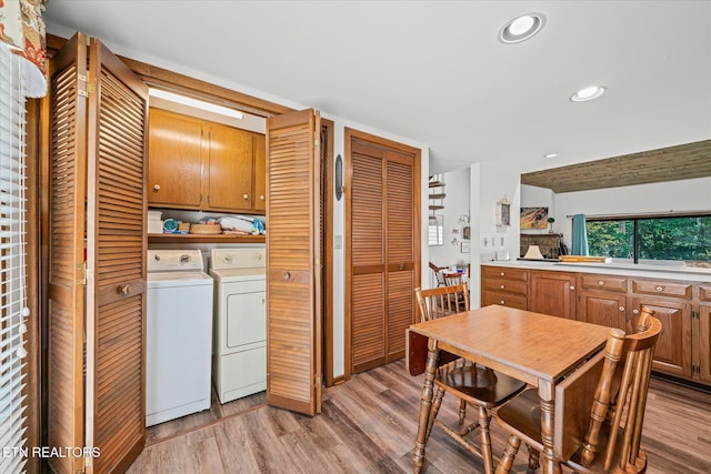 interior space with light hardwood / wood-style flooring, cabinets, and washer and clothes dryer