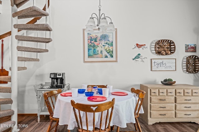 dining space featuring dark hardwood / wood-style flooring and a chandelier