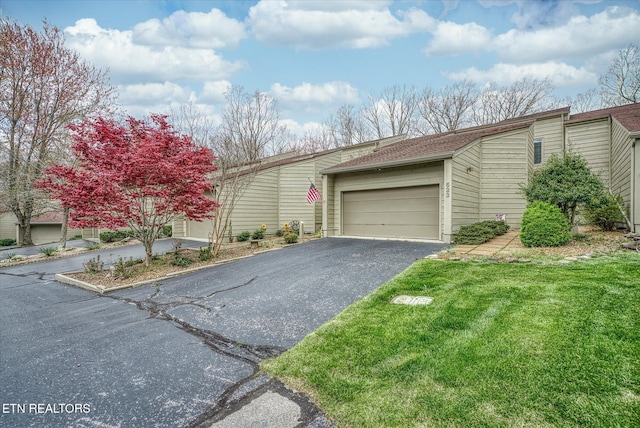 view of front of home featuring a front lawn and a garage