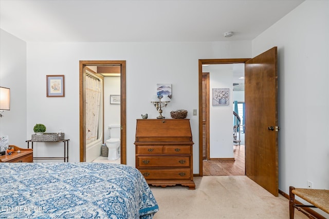 carpeted bedroom with connected bathroom