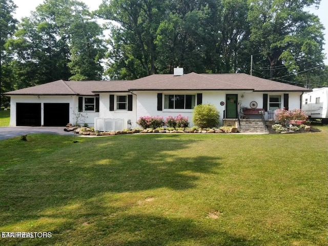 ranch-style home with a front lawn and a garage