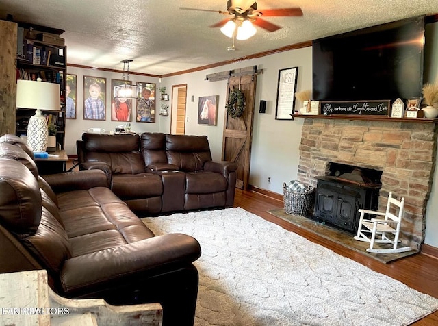 living room with a textured ceiling, ceiling fan, and hardwood / wood-style flooring